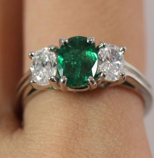 If you're feeling green this Saint Patrick's Day, gorgeous emerald and diamond three stone platinum ring.